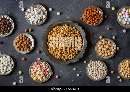 Assortment of roasted chickpeas on dark rustic table, turkish traditional nuts, leblebi Stock Photo