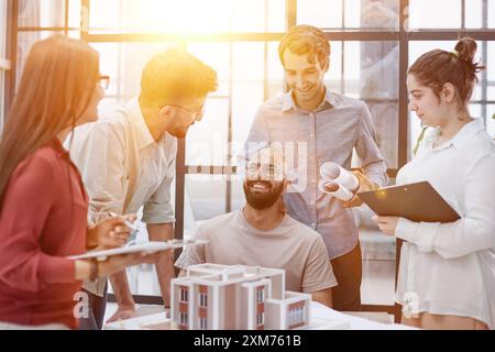Architects and designers working on house layout in office studio. Stock Photo