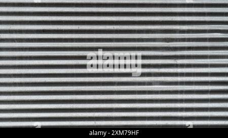 Gray metal shutters, real galvanized sheet metal texture, with deformations in the metal shutter surface Stock Photo