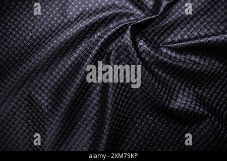 black vegan leather with pattern, fake crumpled textile texture Stock Photo
