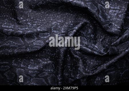 Vegan faux Snakeskin leather texture. minimalist and elegant crumple textile. simple dark black backdrop Stock Photo