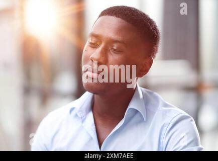 Thoughtful black man in eyeglasses stack with hard task, looking at computer screen, thinking of problem solution Stock Photo