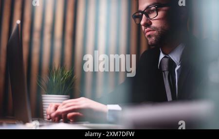 Close up of male hands while typing on laptop Stock Photo