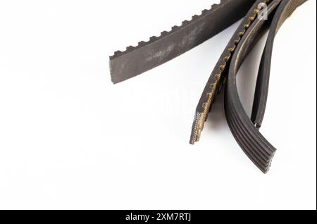 Torn timing belt and generator rivulet belt on a white background. Broken belts in the car, industry. Copy space for text, mechanical Stock Photo