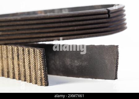 Torn timing belt and generator rivulet belt on a white background. Broken belts in the car, industry Stock Photo