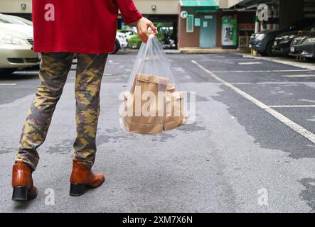 Person carrying grocery bag in the city Stock Photo