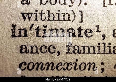 Word intimate on dictionary page, macro close-up Stock Photo