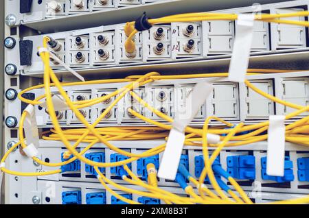 In the server room of the Internet service provider there are many optical cables to router Stock Photo