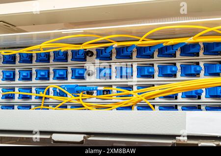 In the server room of the Internet service provider there are many optical cables to router Stock Photo