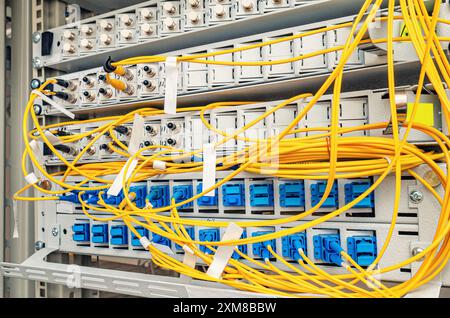 In the server room of the Internet service provider there are many optical cables to router Stock Photo