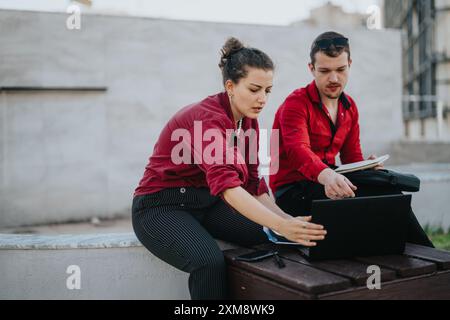 Young business professionals collaborating outdoors in the city Stock Photo