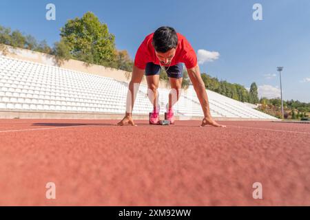 Close up of an athlete in a starting position looking determined and focused Stock Photo