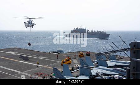 An AS-332 Super Puma helicopter delivers cargo to the flight deck of ...