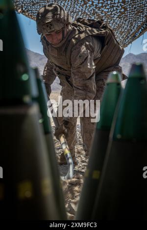 A U.S. Marine with 5th Battalion, 14th Marine Regiment, 4th Marine Division, Marine Forces Reserve, prepares to fire an M777 Howitzer during the second half of a culminating event in support of Integrated Training Exercise (ITX) 4-24 at Marine Corps Air Ground Combat Center, Twentynine Palms, California, June 26, 2024. ITX is a live-fire and maneuver combined arms exercise designed to train battalion and squadron-sized units in tactics, techniques, and procedures that provides a sustainable and ready operational Reserve force.  (U.S. Marine Corps photo by Lance Cpl. Madisyn Paschal) Stock Photo