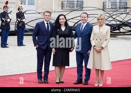 Paris, France. 26th July, 2024. French President Emmanuel Macron and his wife Brigitte Macron welcome President of the Republic of Kosovo Vjosa Osmani Sadriu and her husband Prindon Sadriu as part of the opening of the Paris Olympic Games on July 26, 2024 at Elysee presidential palace in Paris, France. Credit: Bernard Menigault/Alamy Live News Stock Photo