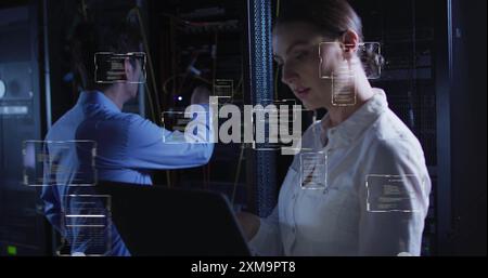 Working on laptop, woman with code snippets over data center background Stock Photo
