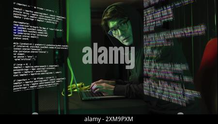 Typing on laptop, person in hoodie surrounded by digital code image. Technology, cybersecurity, hacker, coding, programming, computer Stock Photo