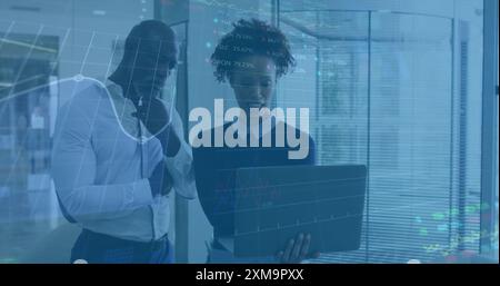 Analyzing financial data on laptop, business people with stock market image over Stock Photo
