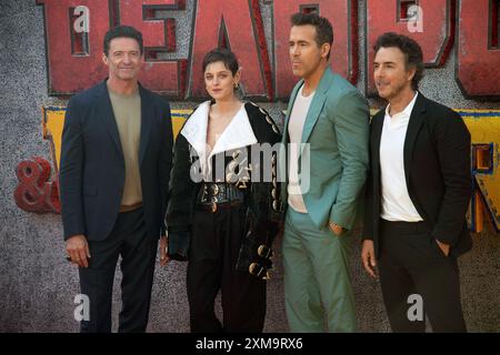 London, UK. 11 Jul, 2024. Pictured: (L-R) - Hugh Jackman, Emma Corrin, Ryan Reynolds, Director Shawn Levy attends The UK Sneak Peek Event of 'Deadpool Stock Photo