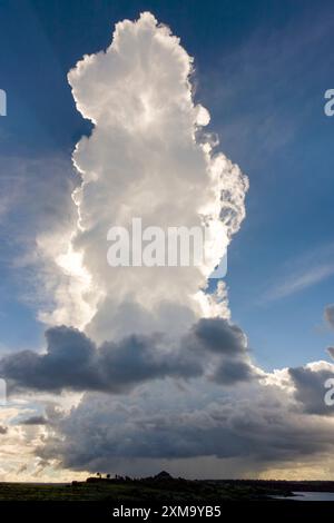 Cumulonimbus thunder clouds. This is one of the largest clouds formed in Earth's weather patterns. They are characterised by a dense, column-like appearance, often with a flat top. They often indicate severe lightning, heavy rain and high winds. Photographed over South Plaza Island in The Galapagos Islands, Ecuador. Stock Photo