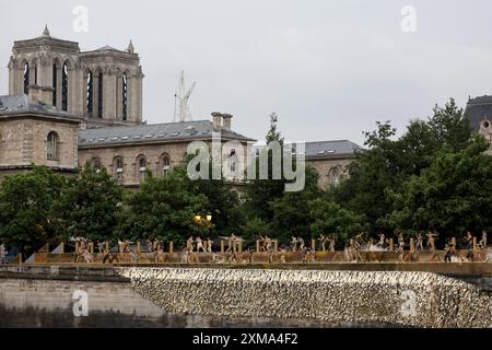 Paris, France. 26th July, 2024. Dancers perform on the banks of the river Seine near Notre-Dame-de-Paris cathedral during the opening ceremony of the Paris 2024 Olympic Games in Paris on July 26, 2024. Credit: Jack Guez/POOL/Xinhua/Alamy Live News Stock Photo