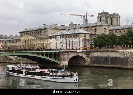 Paris, France. 26th July, 2024. Athletes from Greece's delegation sail in a boat along the river Seine near Notre Dame de Paris cathedral during the opening ceremony of the Paris 2024 Olympic Games in Paris on July 26, 2024. Credit: Jack Guez/POOL/Xinhua/Alamy Live News Stock Photo