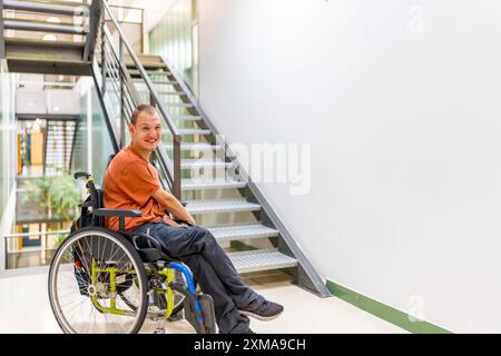 Man with cerebral palsy on a coworking during a work break Stock Photo