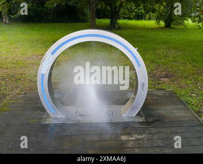 Circular water feature in a park that generates water mist and provides refreshment on hot days, dog shower, Spain Stock Photo