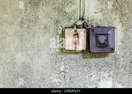 Two Old Plastic Light Switches On A Grunge Dirty Wall Stock Photo