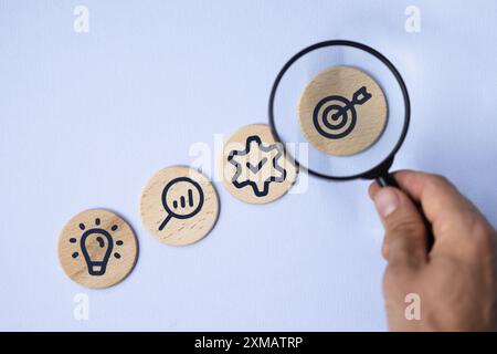 Corporate Growth Strategy: Business Plan Achievement with Team Leadership and Financial Management - Wooden Target Concept on Blue Background Stock Photo