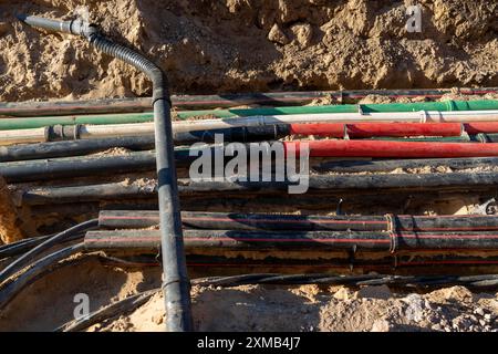 Cables, pipes, next to each other in a construction site, supply lines ...
