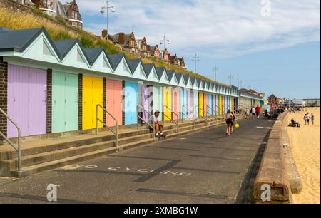 Colourful beach huts and promenade footpath,  South Beach,  Lowestoft, Suffolk, England, UK Stock Photo