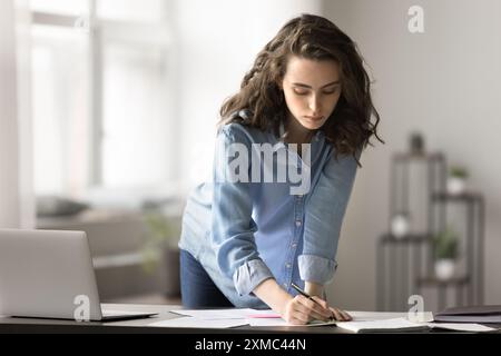 Woman making notes, writing plan working or studying at home Stock Photo
