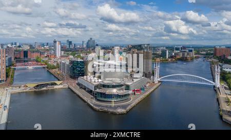 Salford Quays, Manchester waterfront, with the Imperial War Museum, BBC Studios and the Lowry. Skyline of Manchester and Old Trafford. Aerial view Stock Photo