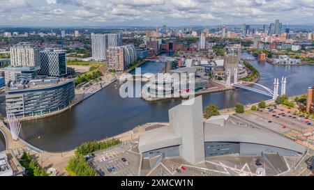 Salford Quays, Manchester waterfront, with the Imperial War Museum, BBC Studios and the Lowry. Skyline of Manchester and Old Trafford. Aerial view Stock Photo