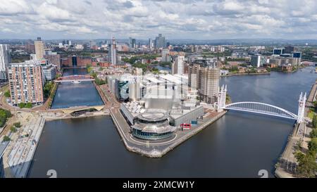 Salford Quays, Manchester waterfront, with the Imperial War Museum, BBC Studios and the Lowry. Skyline of Manchester and Old Trafford. Aerial view Stock Photo