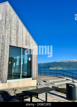 Waiting area for ferry passengers in Sognfjord, Norway. A building with a large window offering a view of a water expanse Stock Photo