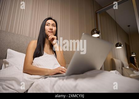 Thoughtful woman freelancer thinking over strategy of project she working at Stock Photo