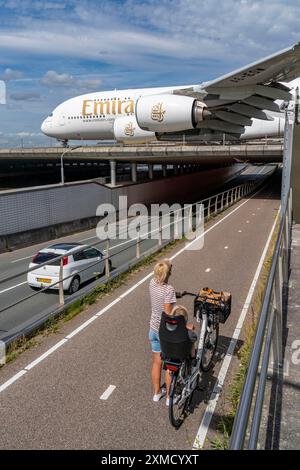 Amsterdam Schiphol Airport, Emirates Airbus A380, on the taxiway, to the Polderbaan runway, bridge over a road and a canal, Amsterdam, Netherlands Stock Photo