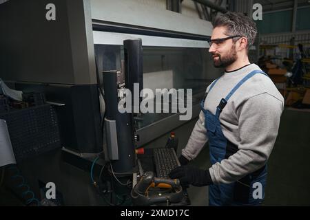 Professional uses modern equipment in production Stock Photo