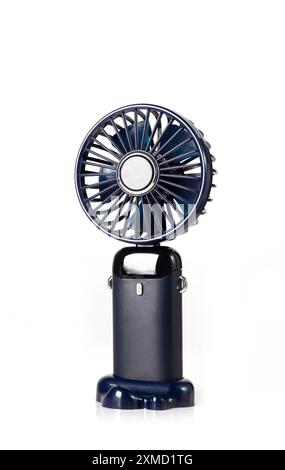 Mini fan for home. Small blue fan isolated on white background. Portable rechargeable mini fans. Close up. Stock Photo