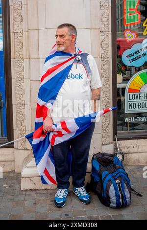 London, England.  27 Jul 24.  Tommy Robinson and Jeremy Corbyn go head to head with march and counter protest: Tommy Robinson today fronted a march billed as a 'Patriotic Rally' from the Strand to Trafalgar Square to 'unite the Kingdom'.  Thousands of self-proclaimed 'patriots' travelled from across the country to Central London to hear him speak.  Meanwhile,  Jeremy Corbyn led a counter-protest organised by 'Stand Up to Racism' in an attempt to 'stop Tommy Robinson'.  Credit: Lab Ky Mo/ALAMY LIVE NEWS Stock Photo