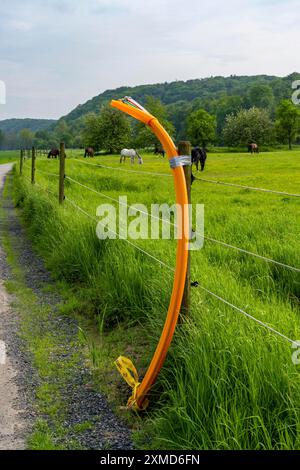 Fibre optic cable, freshly laid along a dirt track, at a paddock, awaiting further expansion, extension, provision of high-speed Internet in rural Stock Photo