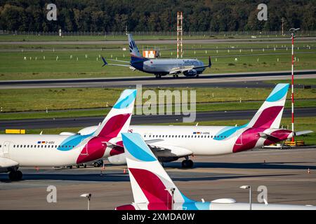 Duesseldorf Airport, Sunexpress Boeing 737 after landing, Eurowings Airbus aircraft in parking position Stock Photo