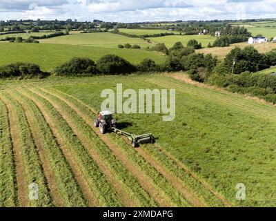 Cork, Ireland. 27th July, 2024. DC 27-7-24 Farmers Take Advantage of Weekends Good Weather, Cork, Ireland. With the warm and dry weather forecast for the week ahead farmers all over the country are taking the opportunity to get work done. Pictured is a farmer in Killcully, Cork cutting his silage, Many farmers will work through the night while the weather stays good to ensure they get all the sileage cut and gathered. Credit: Damian Coleman/17�Թ����� Live News Stock Photo