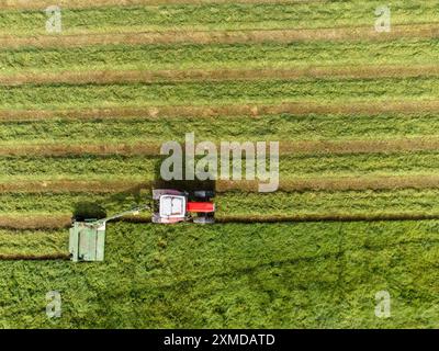 Cork, Ireland. 27th July, 2024. DC 27-7-24 Farmers Take Advantage of Weekends Good Weather, Cork, Ireland. With the warm and dry weather forecast for the week ahead farmers all over the country are taking the opportunity to get work done. Pictured is a farmer in Killcully, Cork cutting his silage, Many farmers will work through the night while the weather stays good to ensure they get all the sileage cut and gathered. Credit: Damian Coleman/Ģ����ý Live News Stock Photo