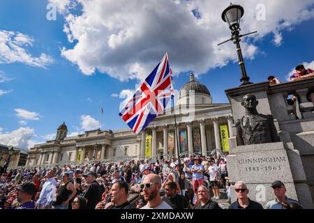 London, UK. 27th July, 2024. Thousands of supporters of Tommy Robinson, real name Stephen Yaxley-Lennon, have marched from the Royal Courts of Justice and are now gathered for a rally in Trafalgar Square, central London. Many have brought Union Jack and St George's Cross flags or are wearing Union Jack colours. Credit: Imageplotter/Alamy Live News Stock Photo