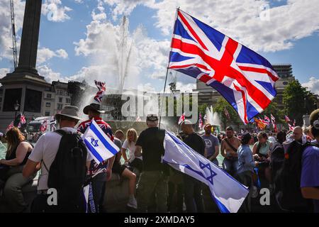 London, UK. 27th July, 2024. Thousands of supporters of Tommy Robinson, real name Stephen Yaxley-Lennon, have marched from the Royal Courts of Justice and are now gathered for a rally in Trafalgar Square, central London. Many have brought Union Jack and St George's Cross flags or are wearing Union Jack colours. Credit: Imageplotter/Alamy Live News Stock Photo