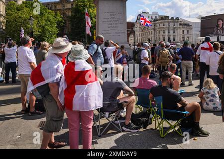 London, UK. 27th July, 2024. Thousands of supporters of Tommy Robinson, real name Stephen Yaxley-Lennon, have marched from the Royal Courts of Justice and are now gathered for a rally in Trafalgar Square, central London. Many have brought Union Jack and St George's Cross flags or are wearing Union Jack colours. Credit: Imageplotter/Alamy Live News Stock Photo