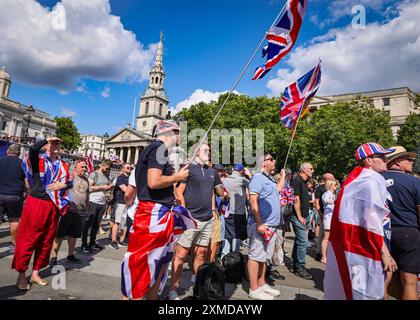 London, UK. 27th July, 2024. Thousands of supporters of Tommy Robinson, real name Stephen Yaxley-Lennon, have marched from the Royal Courts of Justice and are now gathered for a rally in Trafalgar Square, central London. Many have brought Union Jack and St George's Cross flags or are wearing Union Jack colours. Credit: Imageplotter/Alamy Live News Stock Photo